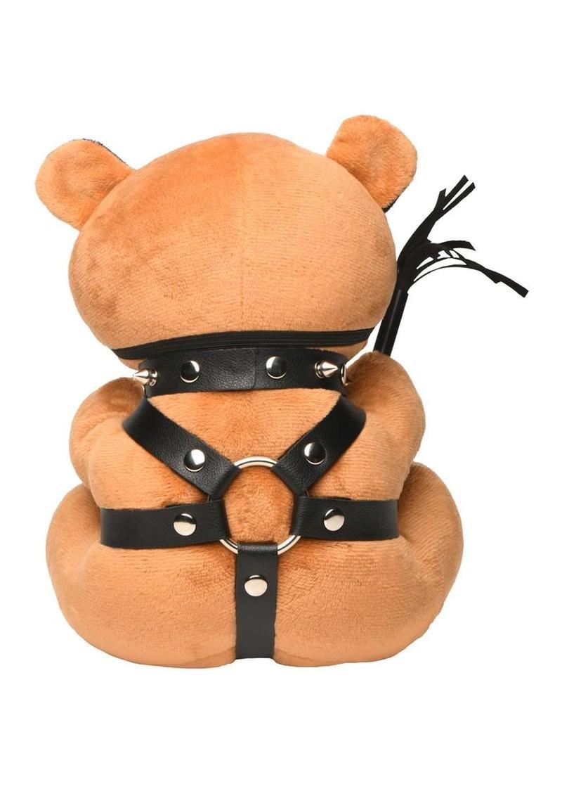 soft teddy bear in black collar and leather harness kink accessory