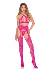 Model wearing a bright pink lace lingerie set on a white background