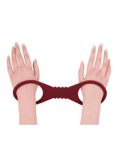 ergonomic silicone cuffs in burgandy  offering flexible restraint and secure bdsm play