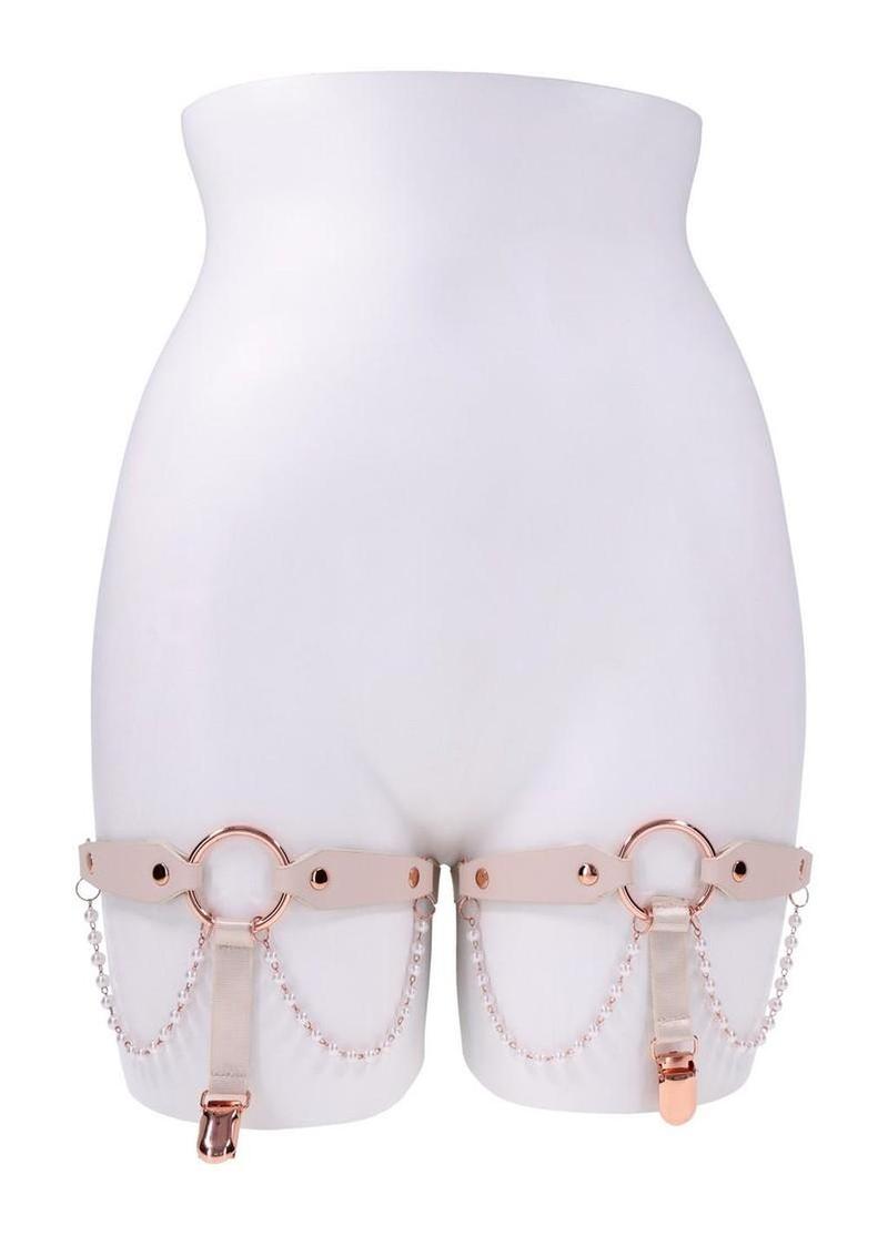 White high-waisted underwear with rose gold garters on a white background